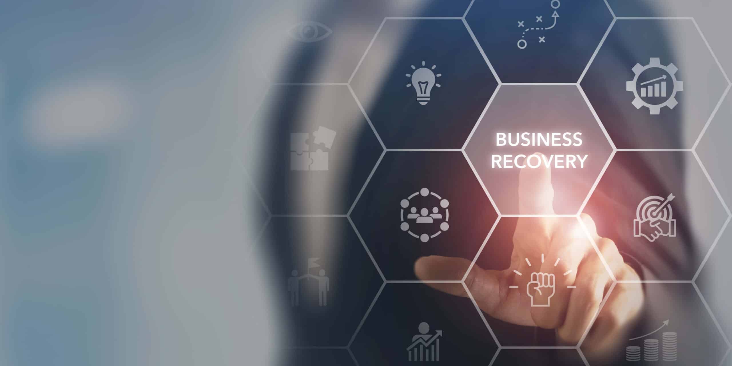 Person pointing at a virtual hexagon labeled Business Recovery with related icons
