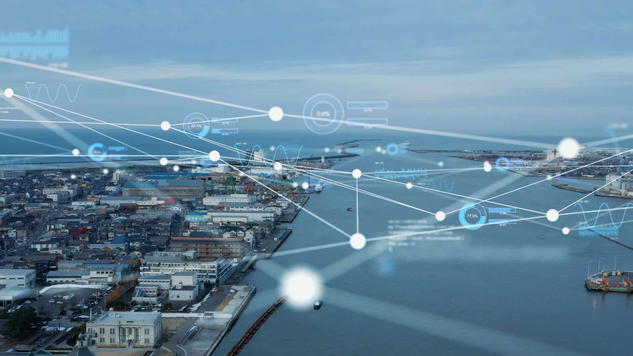 Aerial view of a coastal city with digital data overlay representing connectivity and analytics