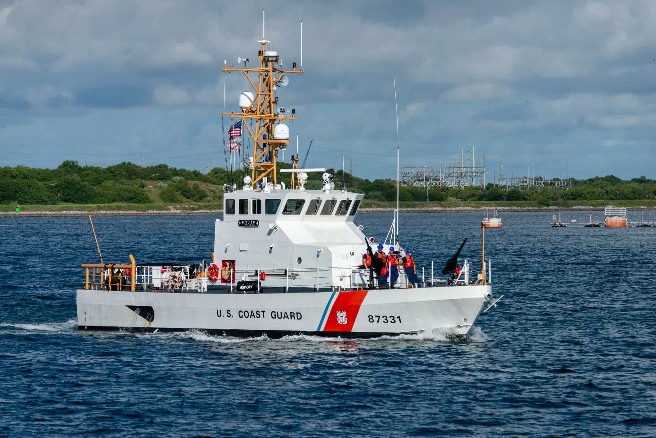 U.S. Coast Guard vessel Moray with crew members on deck in coastal waters